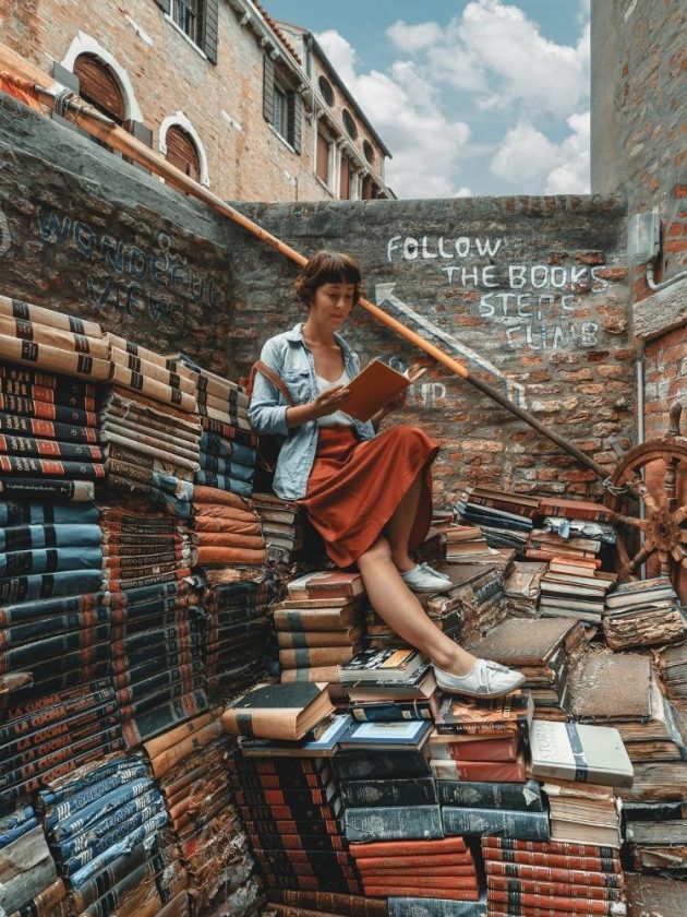 Women sitting on books