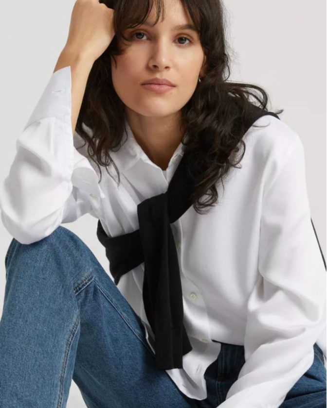 model wearing a white button-up and sweater as a scarf from the slow fashion brand Asket