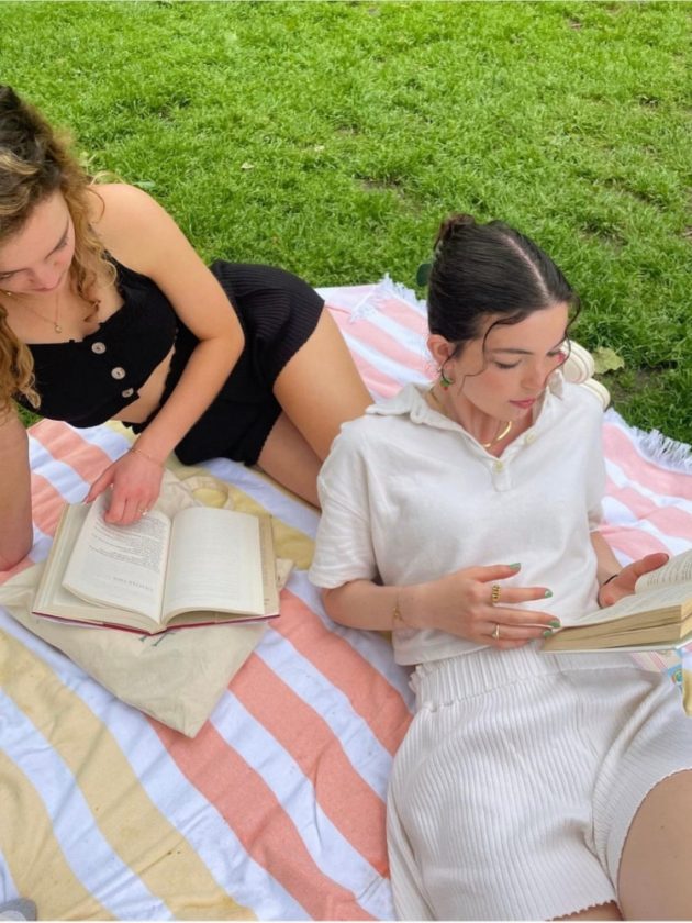 two girls reading wearing affordable sustainable fashion from Oneoff