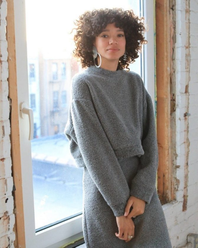 Woman wearing gray sweater and skirt - slow fashion brand Arielle