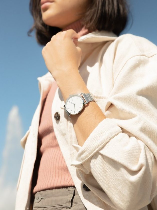 model wearing silver watch from Solios