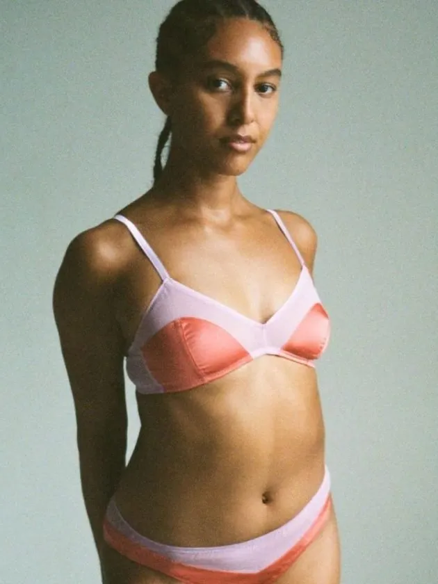 model wearing red and pink sustainable bralette from ethical lingerie brand araks